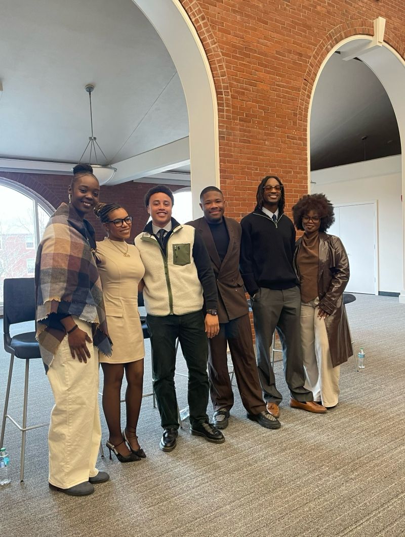 Jaychele with a group at Bentley University during community programming.